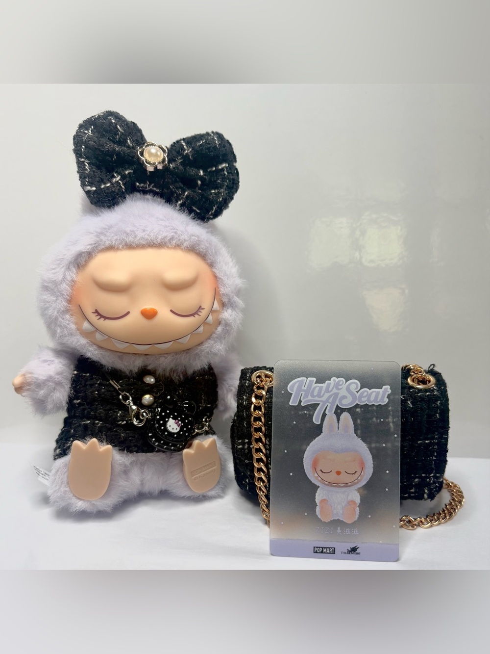 ZiZi “Have a Seat” Labubu in 3 piece outfit and matching mini bag and charm).